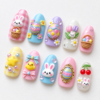 press-on nails featuring bunny characters, baskets of pastel eggs