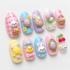 press-on nails featuring bunny characters, baskets of pastel eggs