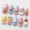 press-on nails featuring bunny characters, baskets of pastel eggs