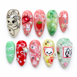 Kawaii bunny press-on nails in pink, mint and cream with strawberries, bows, stars and pearl-like accents
