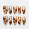 Pearl maple leaf press-on nails with copper foliage, acorns, gold linework and an iridescent ivory base.