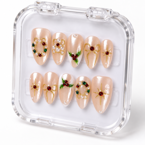 press-on nails with pearly blush-pink bases, red and green accents