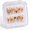 press-on nails with pearly blush-pink bases, red and green accents