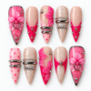 Pink bow press-on nails with hot-pink tips, lace-like textures, silver-tone rings and raised floral details.