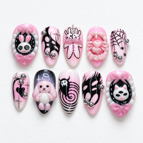 Pink and black press-on nails featuring rabbit and spiderweb patterns.
