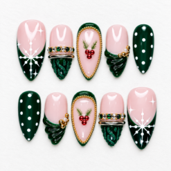 Pink green holly press-on nails with snowflakes, red berry sprigs, emerald accents and gold-tone details.