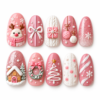 Pink knit christmas press-on nails with a reindeer, bows, ornaments, snowflakes, a wreath and a snowy cottage.