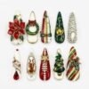 Christmas wreath press-on nails in red, green and ivory with a 3D poinsettia, a glitter wreath, a tree and rhinestones