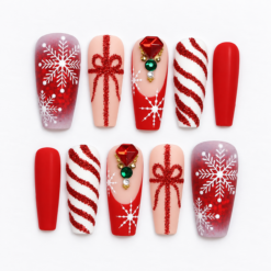 Red snowflake press-on nails with glitter bows, candy-cane stripes, jewel-like accents and white details