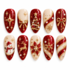 Christmas glitter press-on nails in ruby red, champagne and gold with a snowman, reindeer, bows, stars and snowflakes