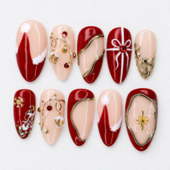 Red gold christmas press-on nails with nude accents, ribbon designs, star details and jewel-like embellishments