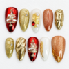 Red gold christmas press-on nails with sculpted Christmas trees, gold accents, starbursts and pearly details.