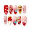 Red peppermint press-on nails with a reindeer, candy swirls, glitter and snowflake designs.