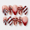 Red and white Christmas press-on nails in blush and burgundy with tree art, candy-cane stripes, snowflakes, bows and rhinestone-style accents