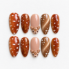 Spotted fawn press-on nails in warm browns with white deer markings, delicate leaf art and a raised fawn face charm.