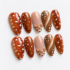 delicate leaf motifs, bronze shimmer and a raised fawn face accent press on nails