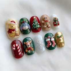 Storybook christmas press-on nails with festive animal characters, a Christmas tree, gingerbread, gifts and candy canes.