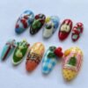 Press-on nails featuring yellow duck and cherry designs.