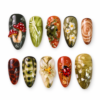 Woodland mushroom press-on nails with red spotted caps, olive leaves, wildflowers and a tiny ladybug.
