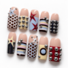 stars, geometric color blocks and raised silver-tone studs on a nud press on nails