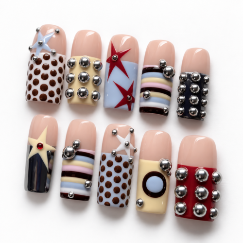 stars, geometric color blocks and raised silver-tone studs on a nud press on nails