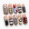 stars, geometric color blocks and raised silver-tone studs on a nud press on nails