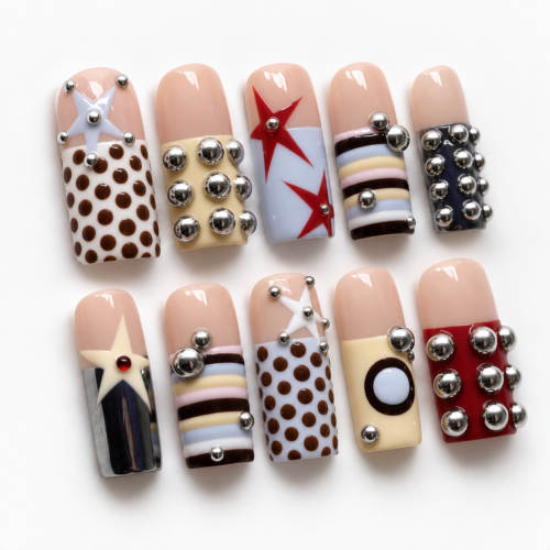 stars, geometric color blocks and raised silver-tone studs on a nud press on nails
